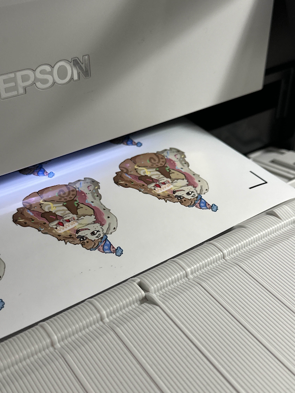 Stickers on the Epson print bed, mid-print.